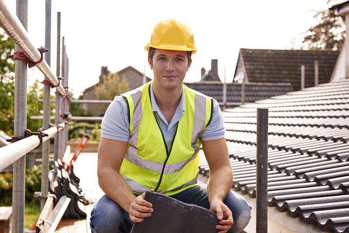 New Build Trusted Team member checking project atop scaffolding